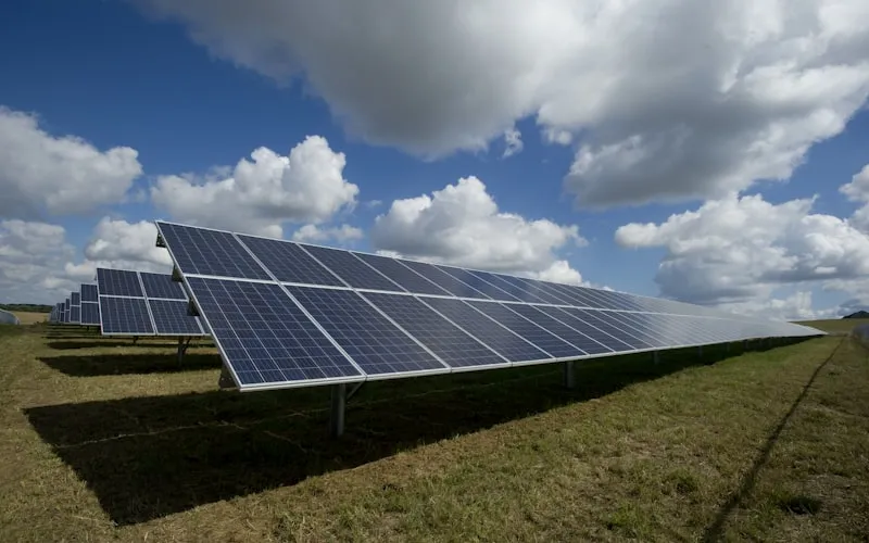 Green technologies concept with solar panels, wind energy and sustainable environment imagery